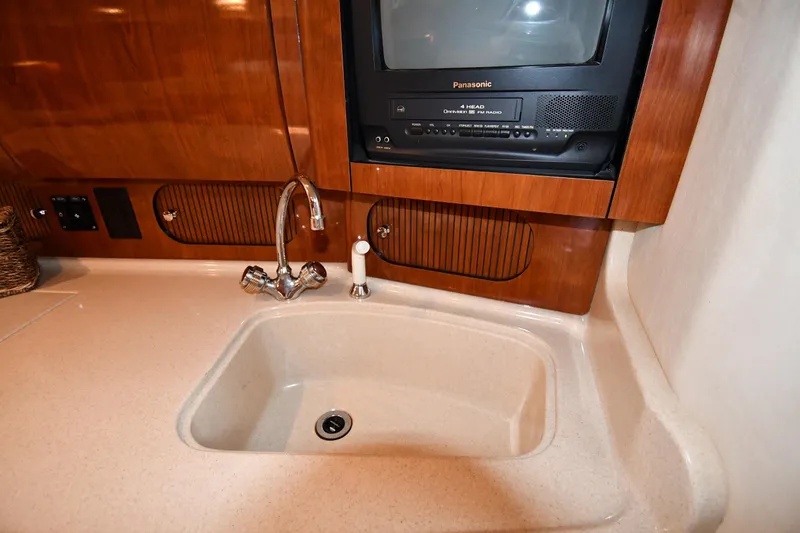 Slide: The Image of 2003 Sea Ray 360 Sundancer galley with sink and built-in Panasonic TV. - 39