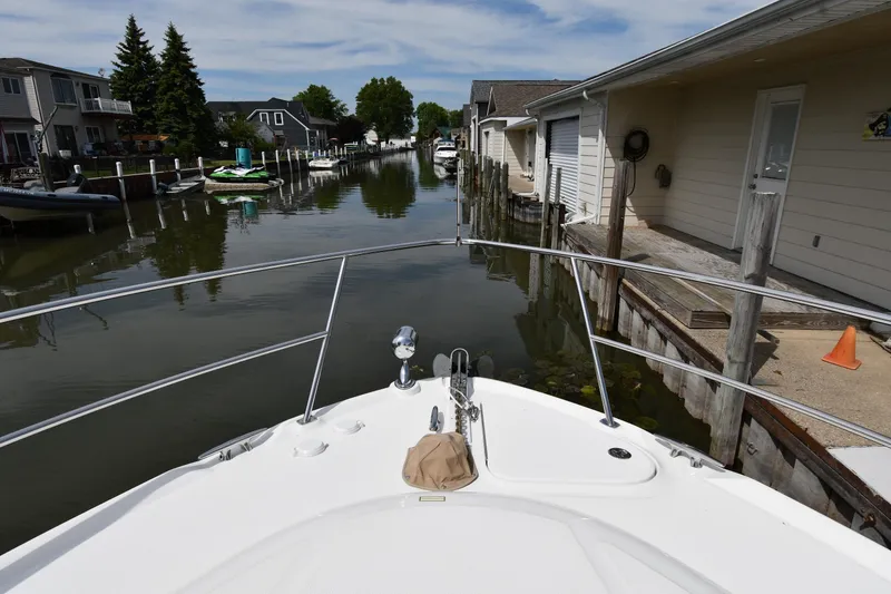 Slide: The Image of Bow view of 2003 Sea Ray 360 Sundancer navigating a narrow canal. - 4