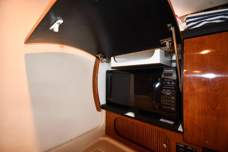 Slide: The Image of 2003 Sea Ray 360 Sundancer interior with microwave and wooden cabinetry. - 41
