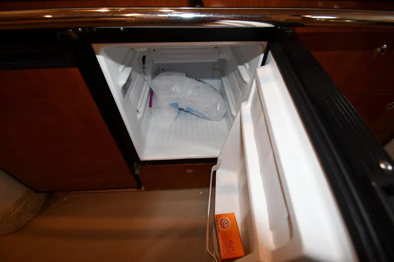 Slide: The Image of Open mini fridge on 2003 Sea Ray 360 Sundancer with ice bag and baking soda. - 43