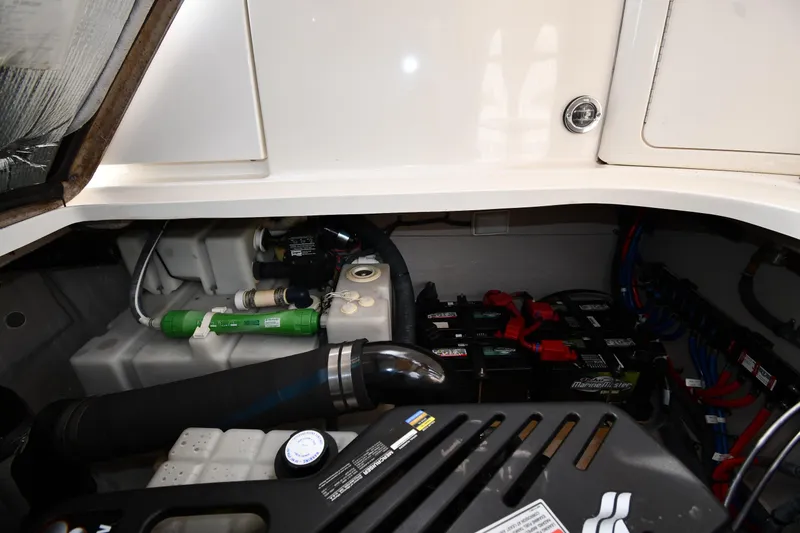 Slide: The Image of Engine compartment of a 2003 Sea Ray 360 Sundancer with visible batteries and components. - 46