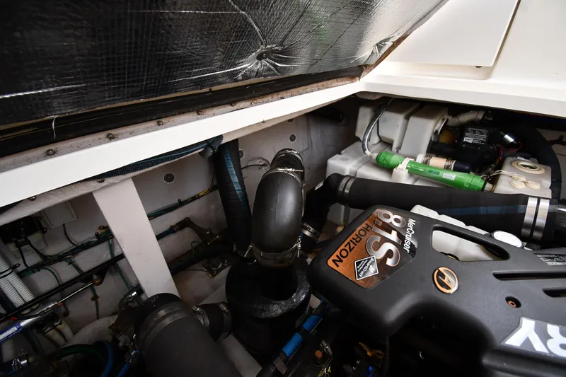 Slide: The Image of Engine compartment of a 2003 Sea Ray 360 Sundancer boat, showcasing mechanical components. - 47