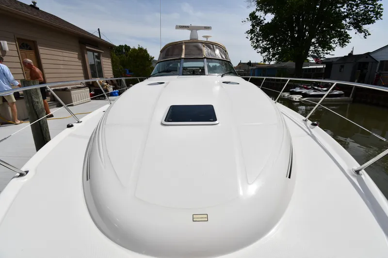 Slide: The Image of 2003 Sea Ray 360 Sundancer yacht docked, showcasing sleek design and spacious deck. - 6