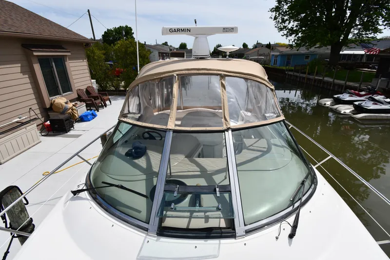 Slide: The Image of 2003 Sea Ray 360 Sundancer docked, featuring Garmin radar and beige canopy. - 7