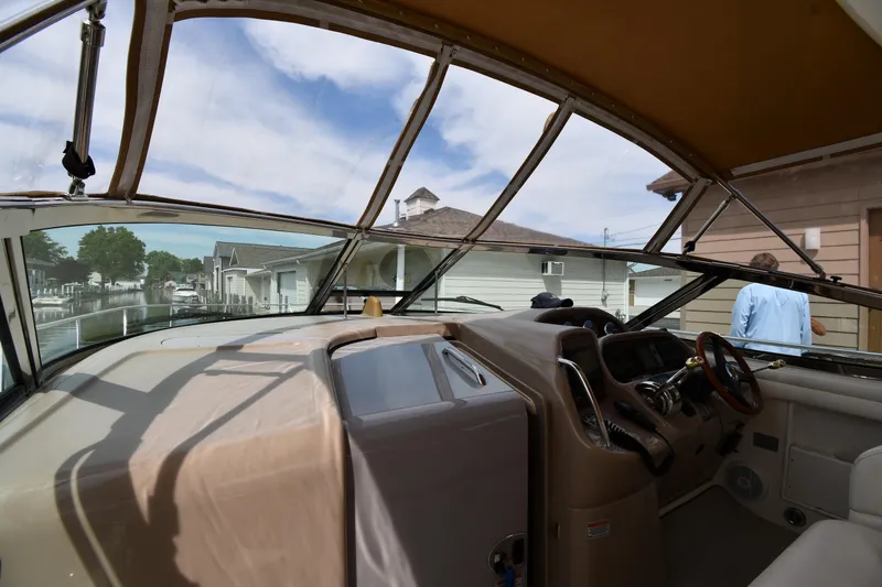 Slide: The Image of 2003 Sea Ray 360 Sundancer cockpit view with marina backdrop. - 9