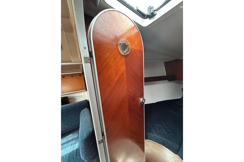 Slide: The Image of Interior cabin view of 1992 Beneteau First 35s5 sailboat with wooden door. - 12