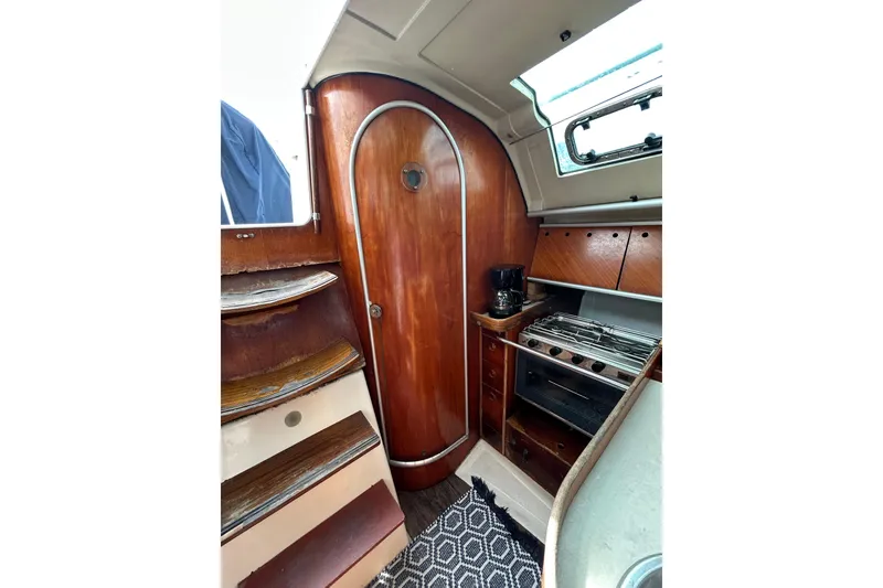 Slide: The Image of Interior of 1992 Beneteau First 35s5 sailboat with wooden cabinetry and compact kitchen. - 14