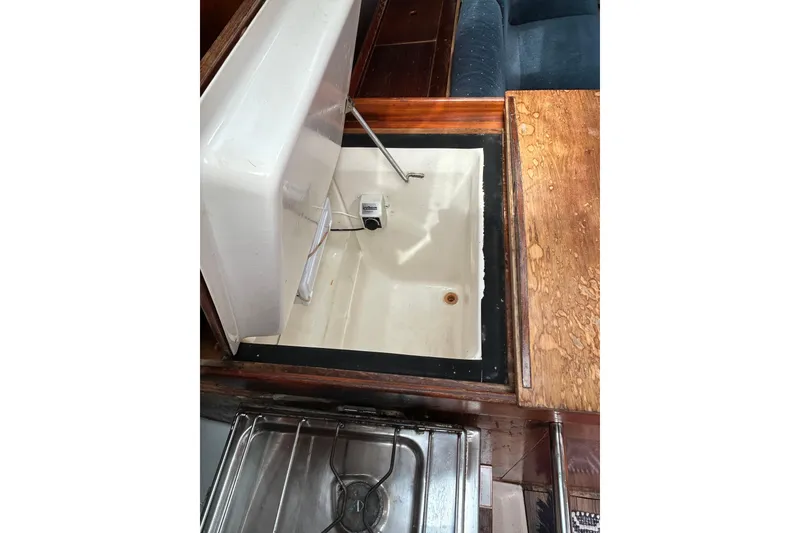 Slide: The Image of Interior view of a 1992 Beneteau First 35s5 yacht galley with open storage compartment. - 19