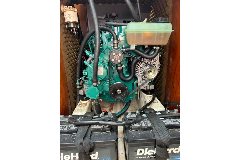 Slide: The Image of Engine compartment of a 1992 Beneteau First 35s5 sailboat, featuring a well-maintained motor. - 23