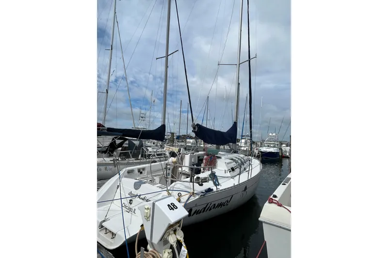 Slide: The Image of 1992 Beneteau First 35s5 sailboat docked in a marina under cloudy skies. - 3