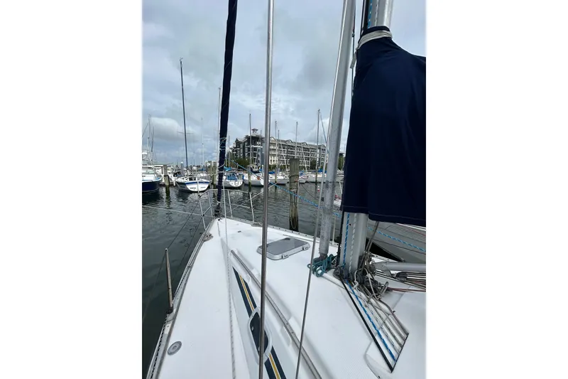 Slide: The Image of 1992 Beneteau First 35s5 sailboat docked in a marina, overcast sky. - 5