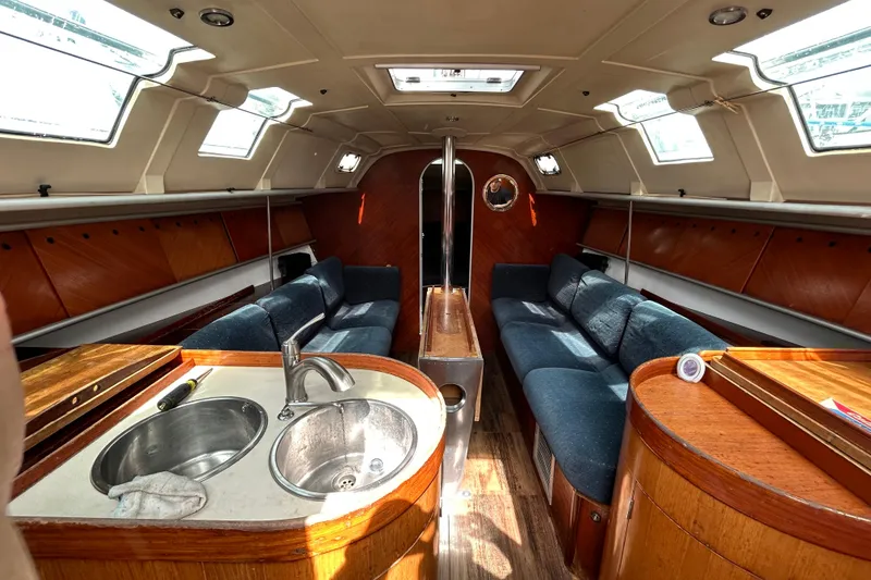 Slide: The Image of Interior of a 1992 Beneteau First 35s5 sailboat with cozy seating and kitchenette. - 9