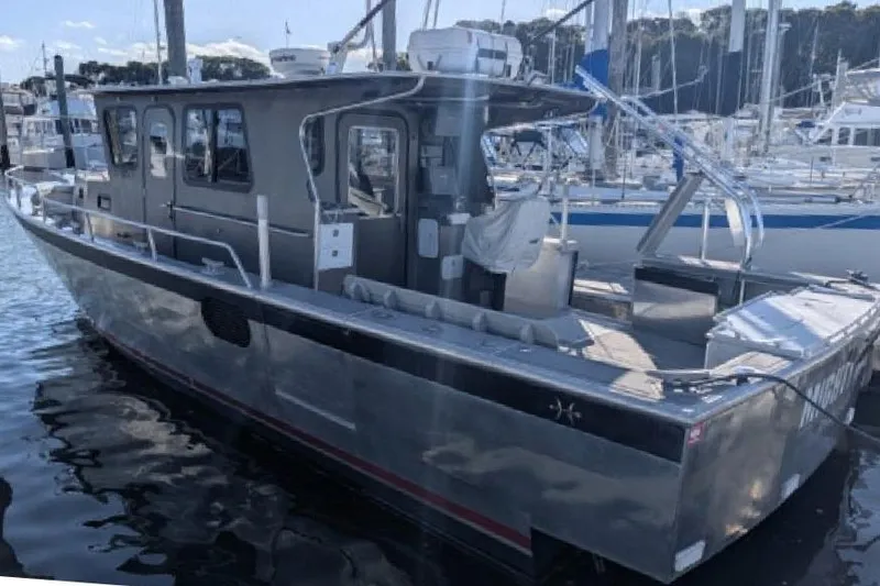 The Image of 2009 Hunt 35 boat docked at marina, featuring sleek design and spacious deck. - 1