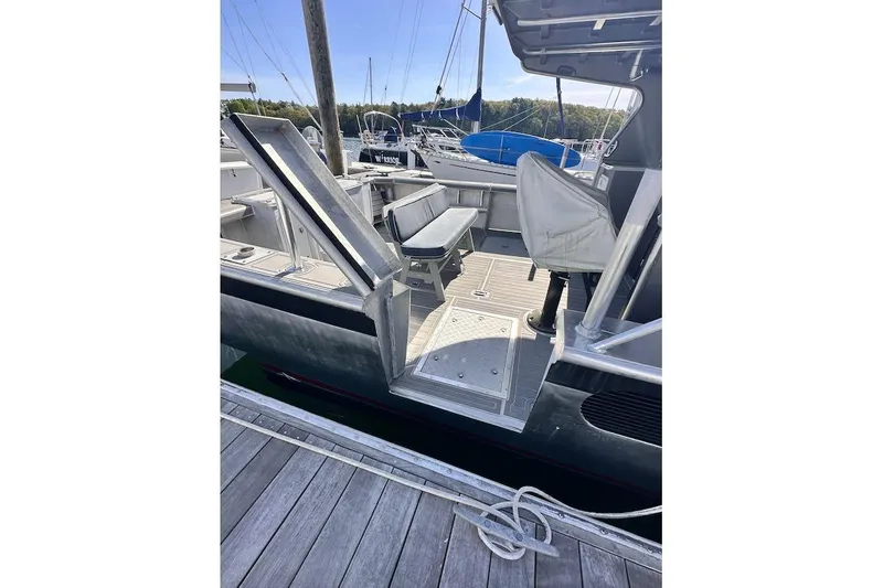Slide: The Image of 2009 Hunt 35 boat docked, featuring open deck and covered seating area. - 10