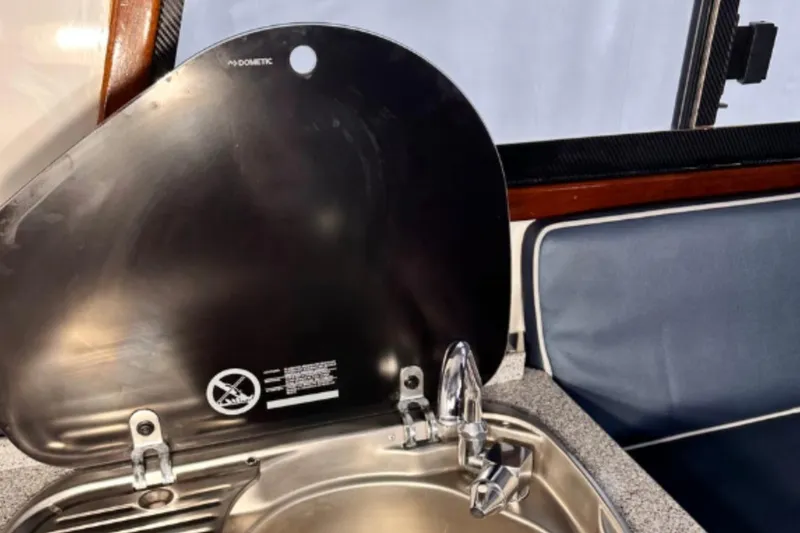 Slide: The Image of Compact kitchen sink with cover in 2009 Hunt 35 boat interior. - 13