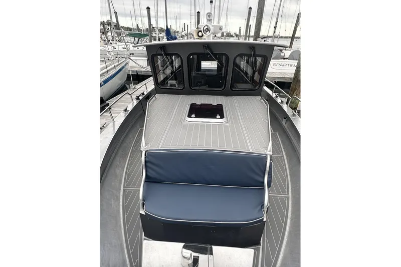 Slide: The Image of 2009 Hunt 35 boat with blue seating, docked at a marina. - 15