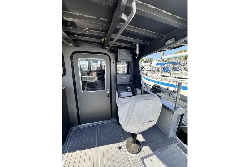 Slide: The Image of Interior of a 2009 Hunt 35 boat with control panel and seating. - 17