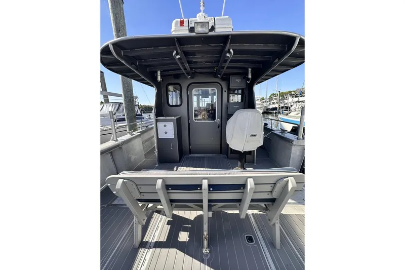 Slide: The Image of 2009 Hunt 35 boat interior with seating and helm, docked at marina. - 18