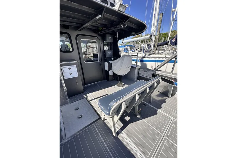 Slide: The Image of 2009 Hunt 35 boat interior with seating and control area, docked at marina. - 19