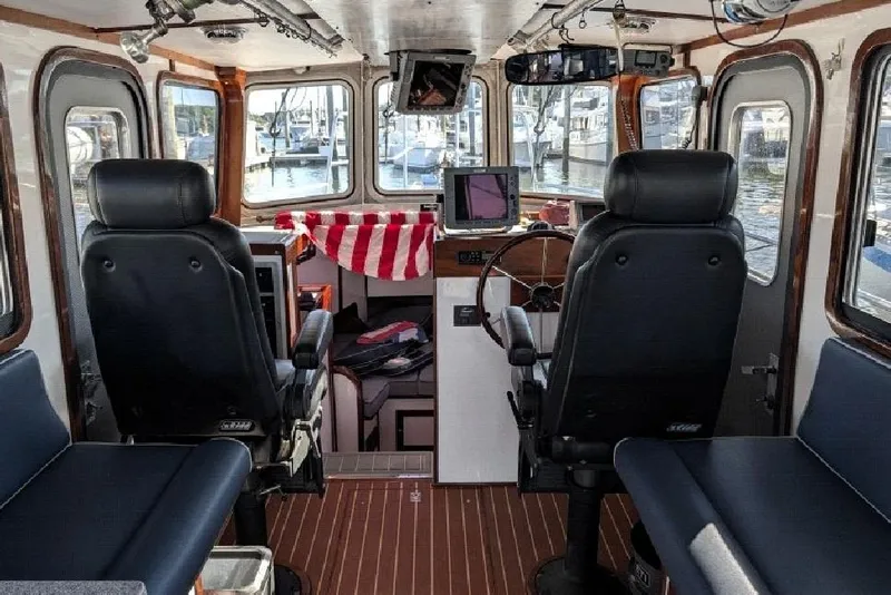 Slide: The Image of Interior of a 2009 Hunt 35 boat with leather seats and navigation equipment. - 4