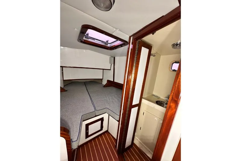 Slide: The Image of Interior of 2009 Hunt 35 boat with cozy cabin and compact bathroom. - 6