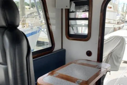 Slide: The Image of Interior of a 2009 Hunt 35 boat with leather seating and wooden table. - 7