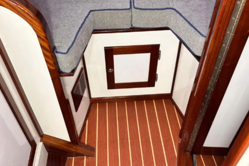 Slide: The Image of Interior of a 2009 Hunt 35 boat with wood accents and striped flooring. - 9