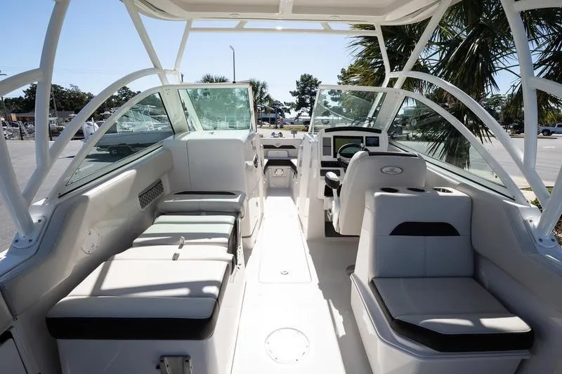 Slide: The Image of 2023 Sailfish 245 DC boat interior with seating and helm, showcasing modern design. - 14