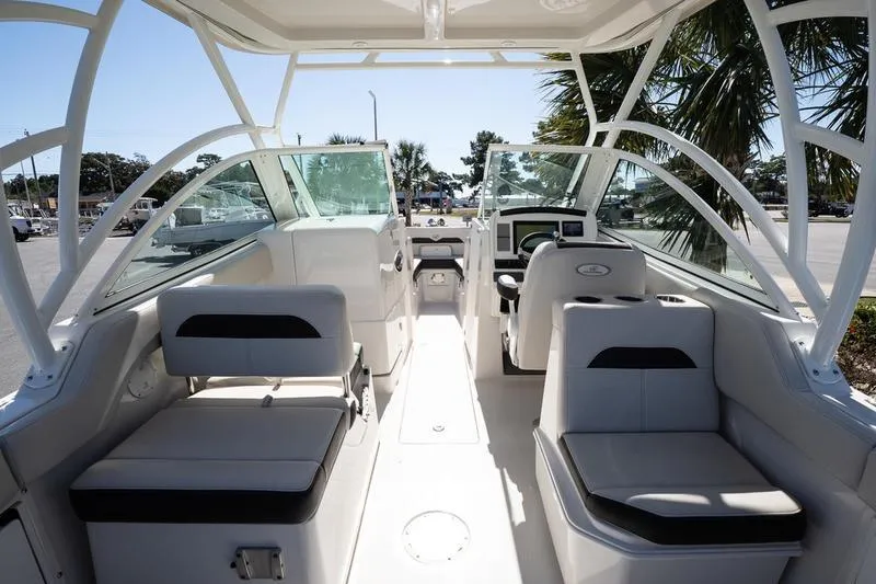 Slide: The Image of 2023 Sailfish 245 DC boat interior with seating and helm, showcasing modern design. - 15