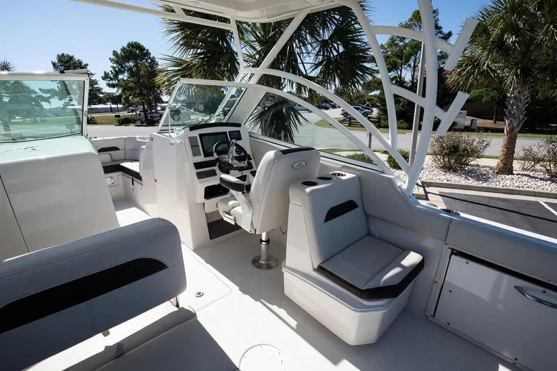 Slide: The Image of 2023 Sailfish 245 DC boat interior with modern seating and steering console. - 16