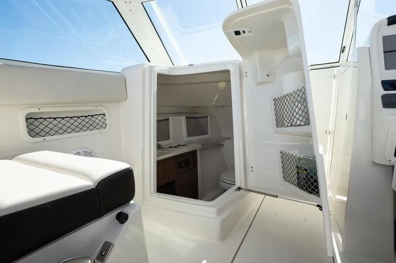 Slide: The Image of 2023 Sailfish 245 DC boat interior with open storage and seating area. - 22