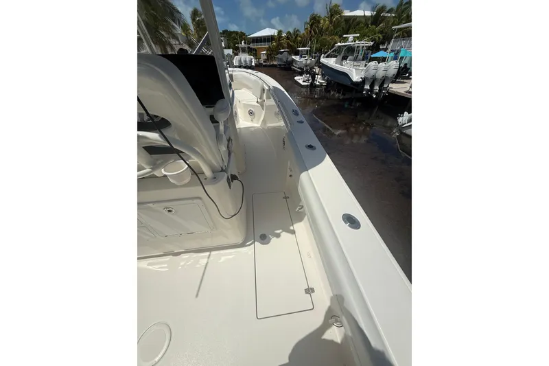 Slide: The Image of 2024 Cobia 280 Center Console boat deck with seating and storage. - 11