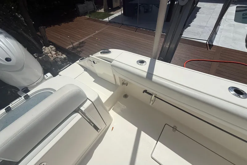 Slide: The Image of 2024 Cobia 280 Center Console boat deck with seating and storage compartments. - 4