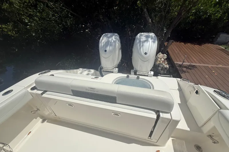 Slide: The Image of 2024 Cobia 280 Center Console boat with dual engines and spacious seating area. - 6