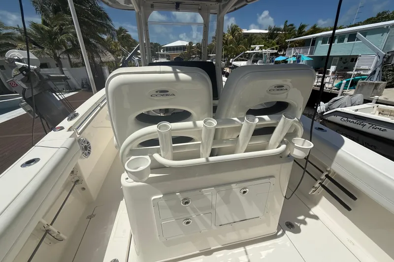 Slide: The Image of 2024 Cobia 280 Center Console boat interior with rod holders and seating. - 7