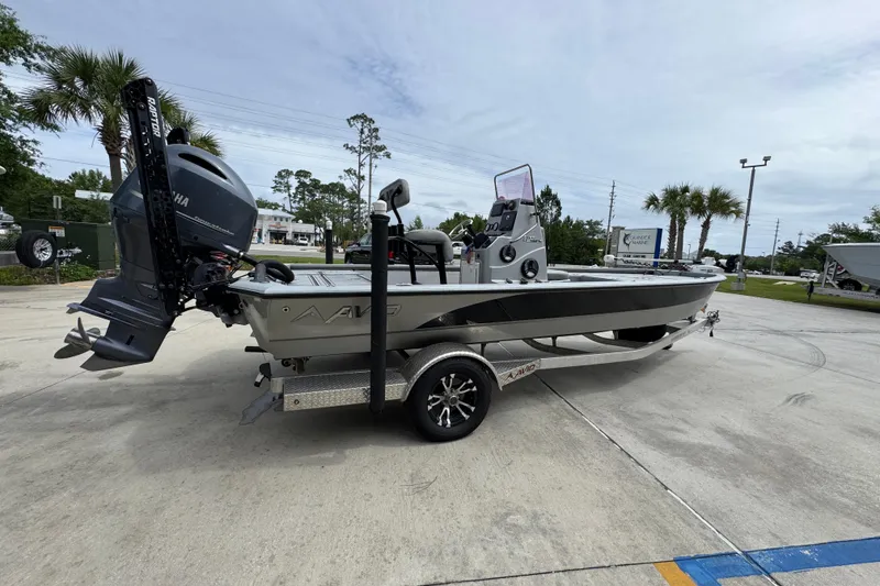 Slide: The Image of 2021 Avid 21 FS boat on trailer with Yamaha outboard motor, parked outdoors. - 10