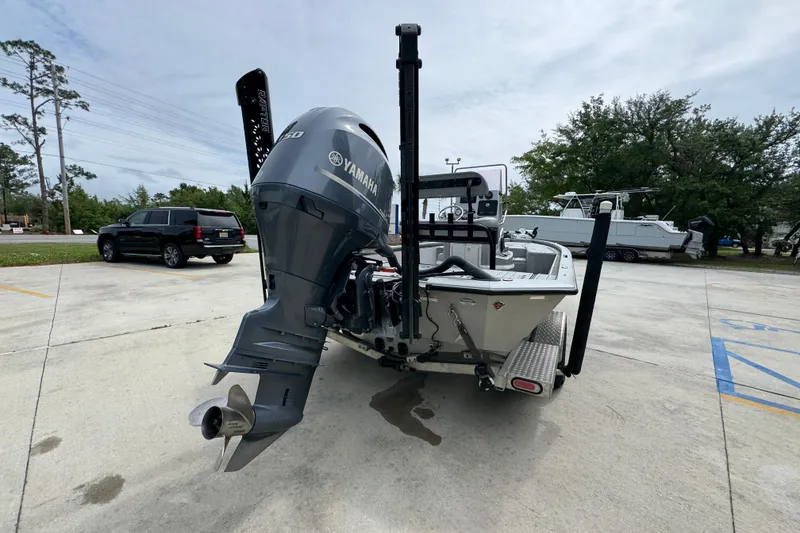 Slide: The Image of 2021 Avid 21 FS boat with Yamaha outboard motor in a parking lot. - 12