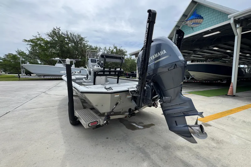 Slide: The Image of Avid 21 FS 2021 boat with Yamaha outboard motor in a marina setting. - 14