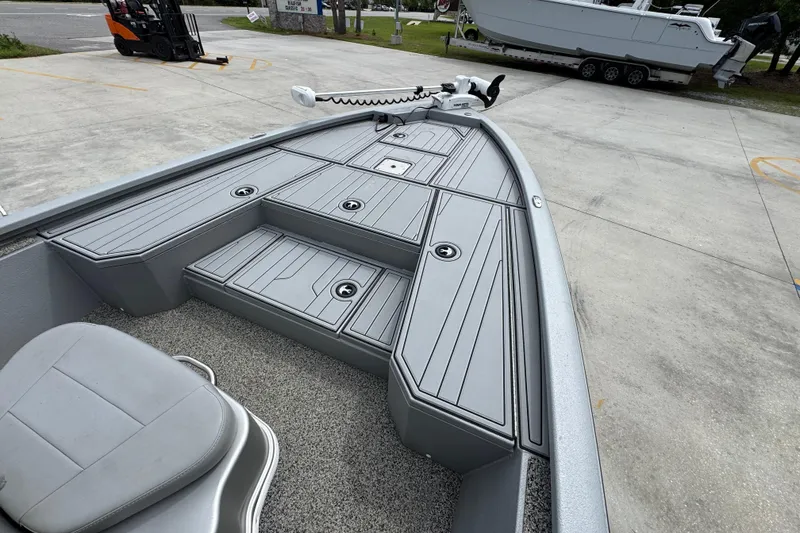 Slide: The Image of 2021 Avid 21 FS boat deck with storage compartments and seating. - 16