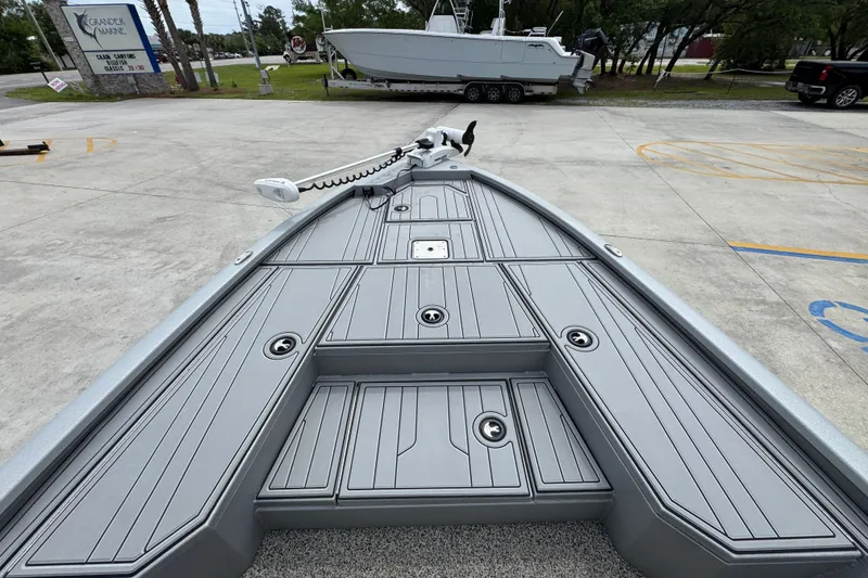 Slide: The Image of Bow view of 2021 Avid 21 FS boat with sleek gray deck design. - 17