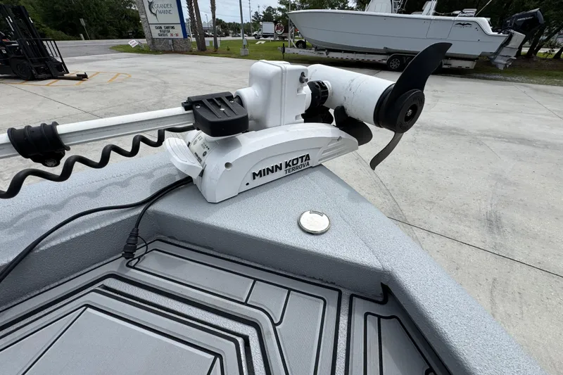 Slide: The Image of Minn Kota Terrova trolling motor on 2021 Avid 21 FS boat, parked outdoors. - 19