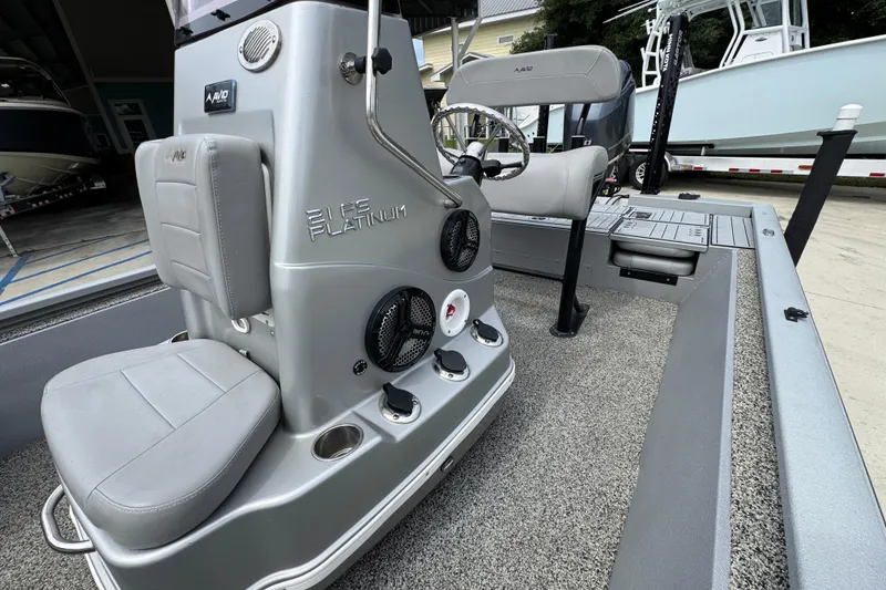 Slide: The Image of 2021 Avid 21 FS boat interior with steering console and seating. - 23