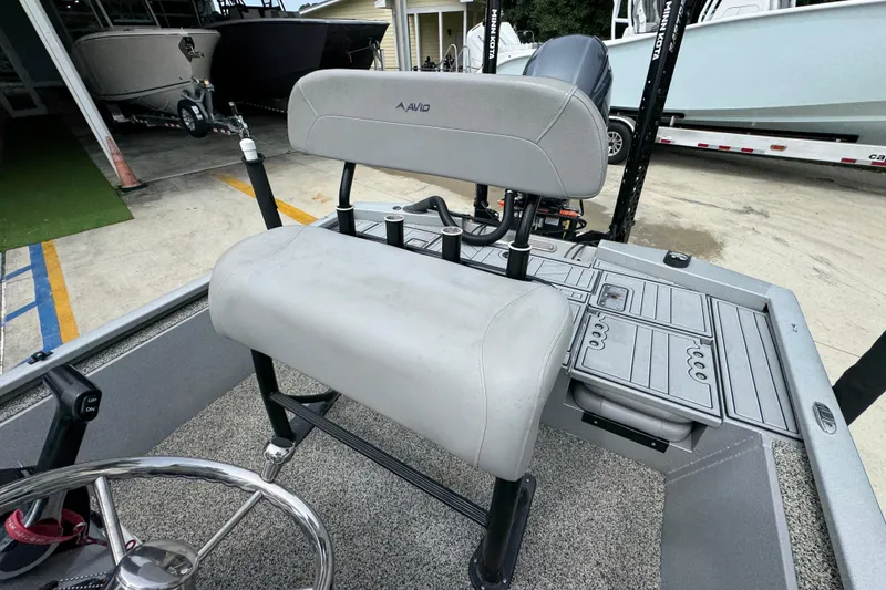 Slide: The Image of 2021 Avid 21 FS boat interior with gray seating and steering wheel. - 25