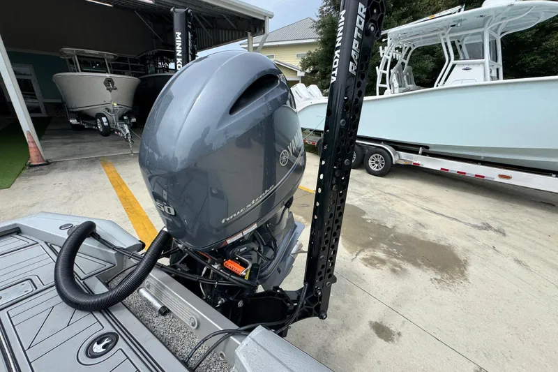 Slide: The Image of 2021 Avid 21 FS boat with Yamaha outboard motor in a marina setting. - 32