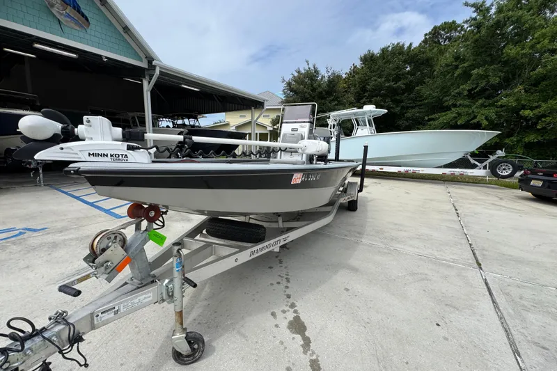 Slide: The Image of 2021 Avid 21 FS boat on trailer with Minn Kota motor in parking area. - 4