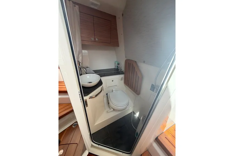 Slide: The Image of Interior of 2022 Boston Whaler 380 Realm boat bathroom with sink and toilet. - 11