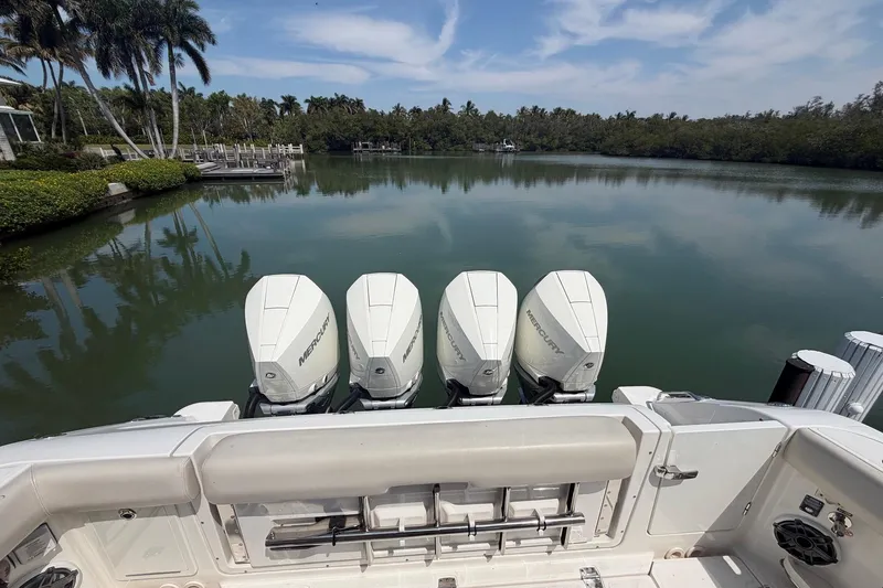 Slide: The Image of Boston Whaler 380 Realm 2022 with four Mercury engines on calm water. - 2