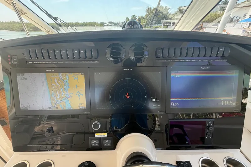 Slide: The Image of Dashboard of 2022 Boston Whaler 380 Realm with navigation screens and controls. - 6