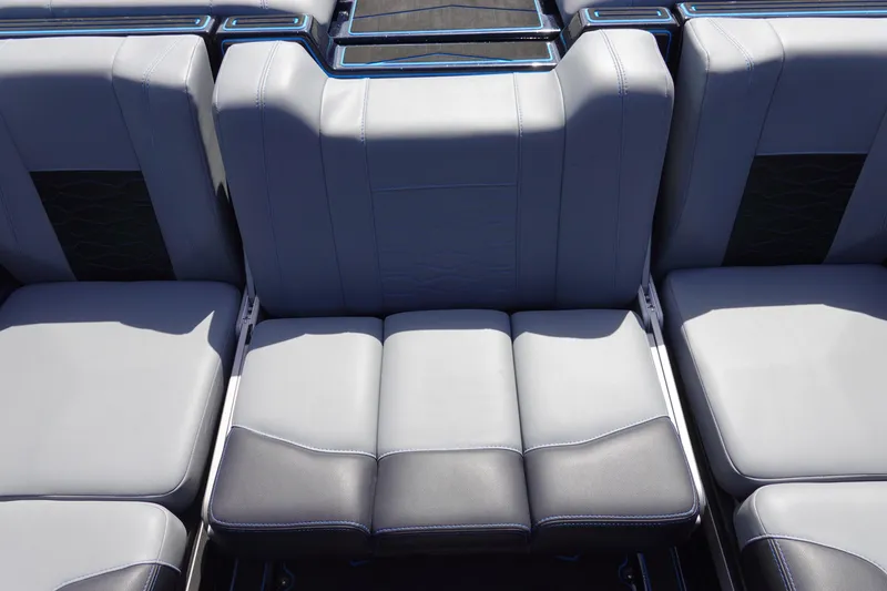 Slide: The Image of 2024 Malibu Wakesetter 23 MXZ interior seating, featuring sleek gray upholstery and modern design. - 11