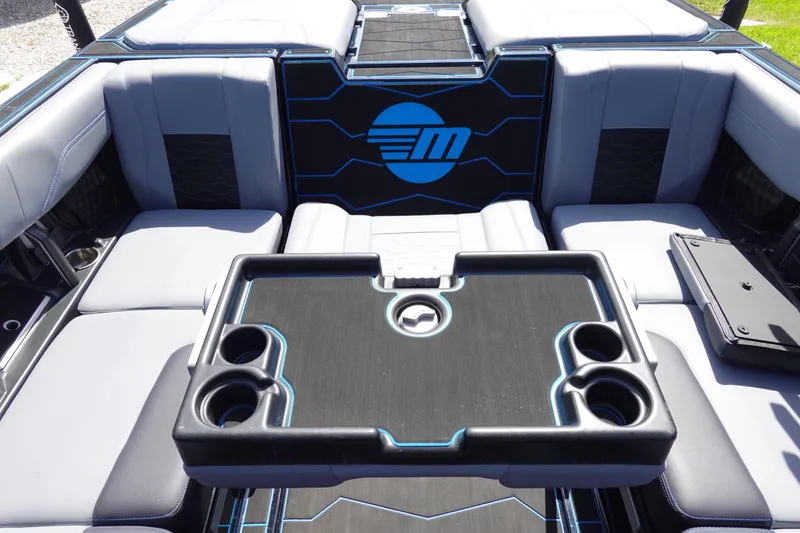 Slide: The Image of 2024 Malibu Wakesetter 23 MXZ interior with seating and cup holders. - 13
